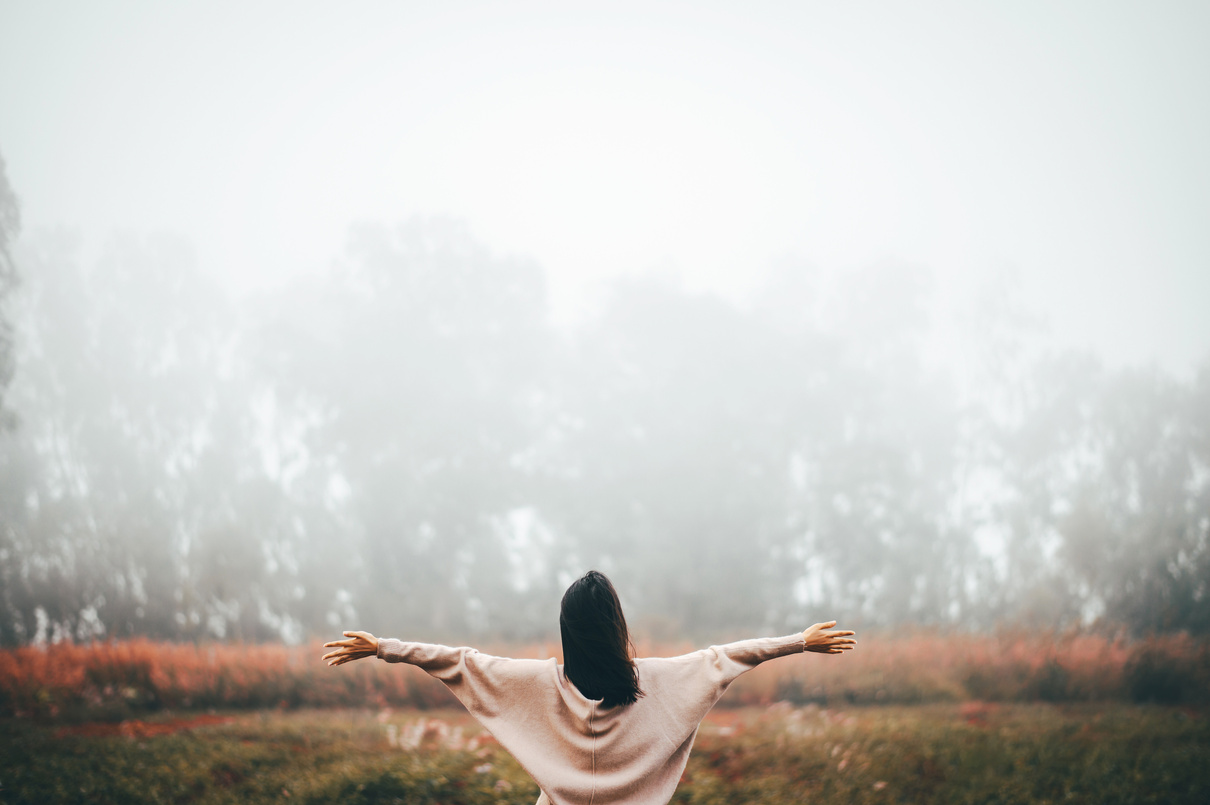 Woman Relaxing and Enjoying the Freedom in Morning Mist